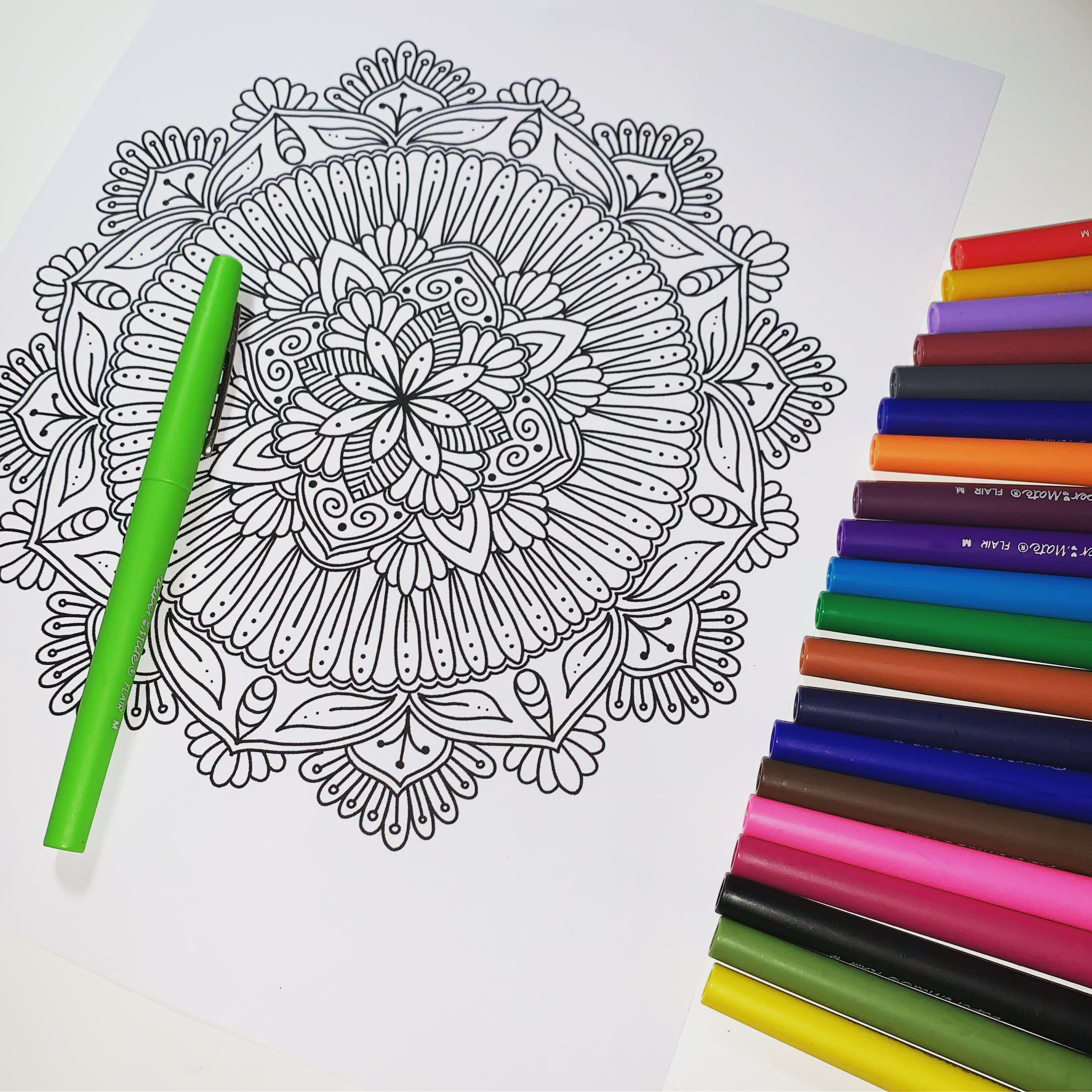 Mandala drawing in progress with colored markers